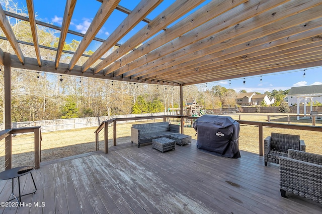 wooden deck featuring area for grilling, outdoor lounge area, and a playground