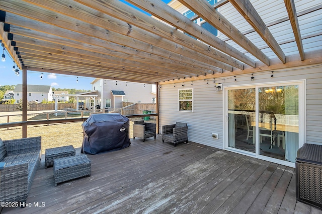 wooden deck with an outdoor living space and grilling area