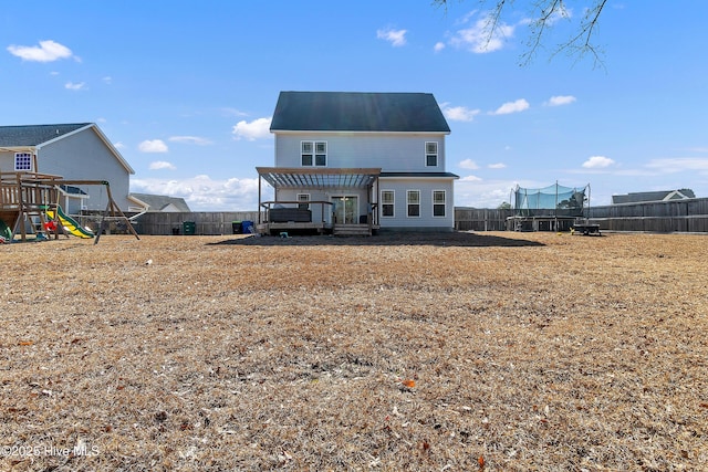 back of house featuring a playground, a trampoline, and a pergola