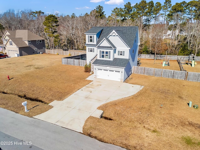 view of front facade with a garage and a front lawn