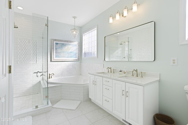 bathroom with vanity, tile patterned floors, and shower with separate bathtub