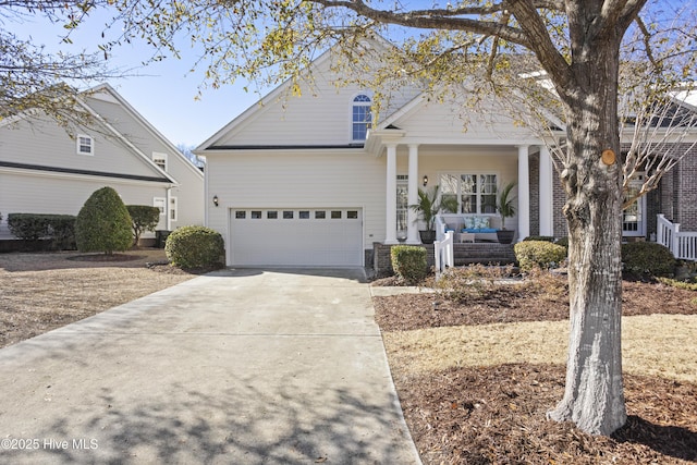 view of front of home featuring a porch and a garage