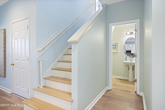 stairway with hardwood / wood-style flooring