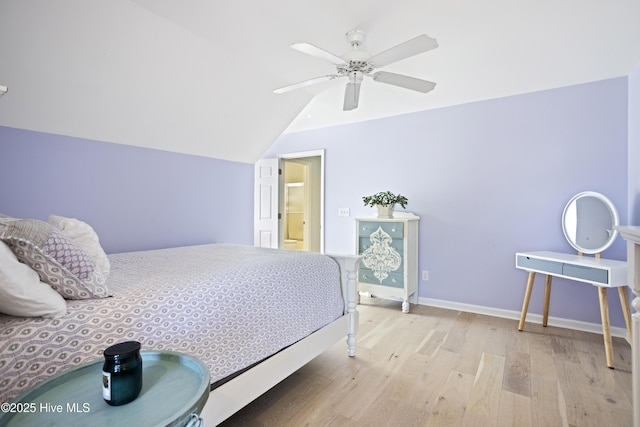 bedroom featuring vaulted ceiling, ceiling fan, and light wood-type flooring