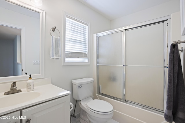 full bathroom with vanity, combined bath / shower with glass door, and toilet