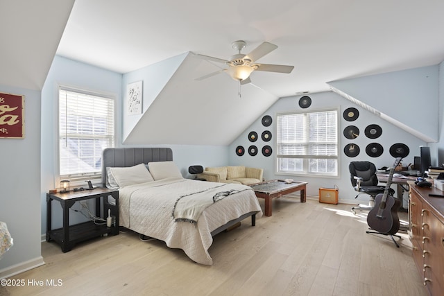 bedroom with ceiling fan, lofted ceiling, and light hardwood / wood-style floors