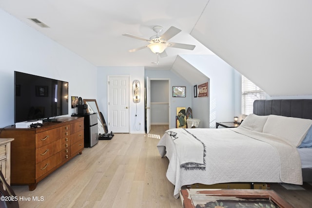 bedroom featuring vaulted ceiling, ceiling fan, and light hardwood / wood-style flooring