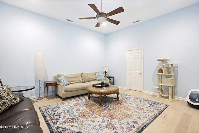 living room with ceiling fan and light hardwood / wood-style flooring