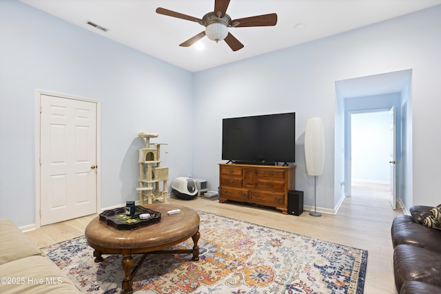 living room featuring ceiling fan and light hardwood / wood-style floors