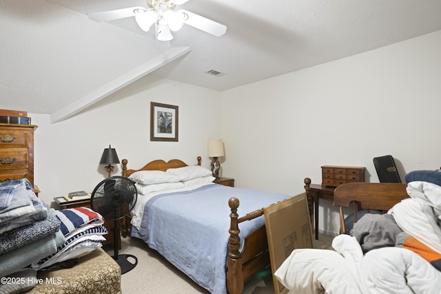 bedroom with a textured ceiling, carpet floors, ceiling fan, and vaulted ceiling