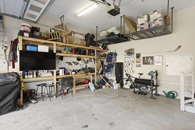 garage with a garage door opener and a workshop area