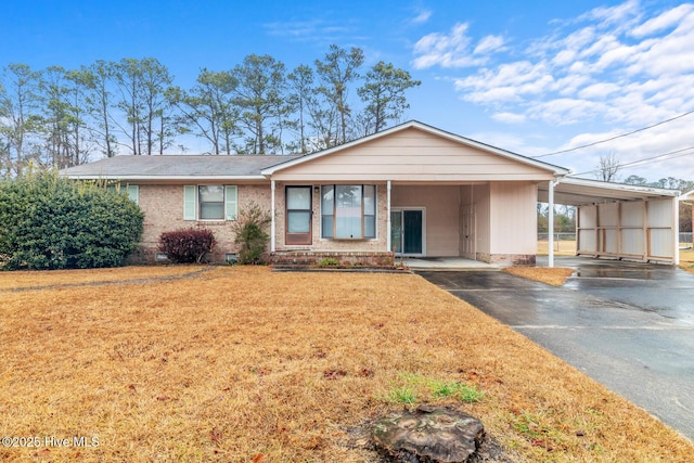 ranch-style home with a carport and a front lawn