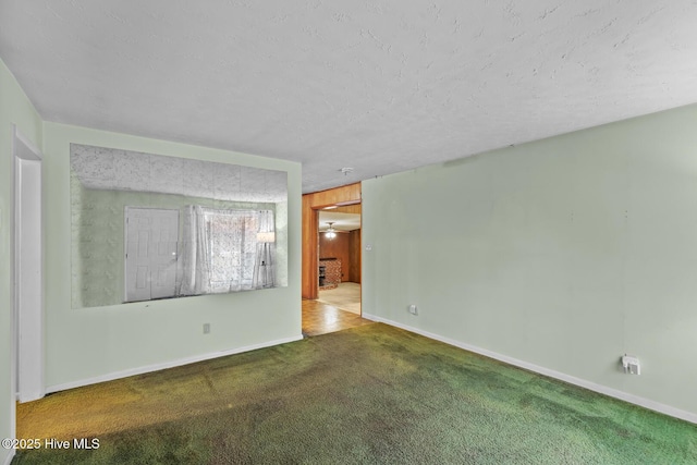 unfurnished room with carpet and wood walls