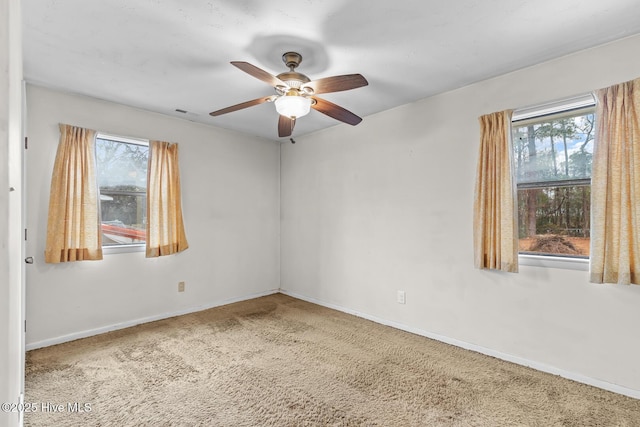 carpeted empty room featuring ceiling fan