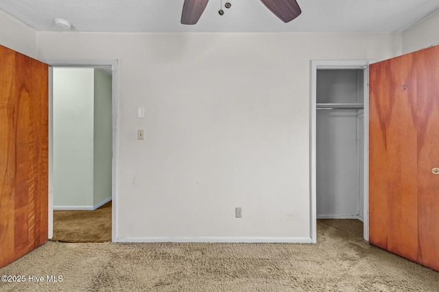 unfurnished bedroom featuring light carpet, ceiling fan, and a closet