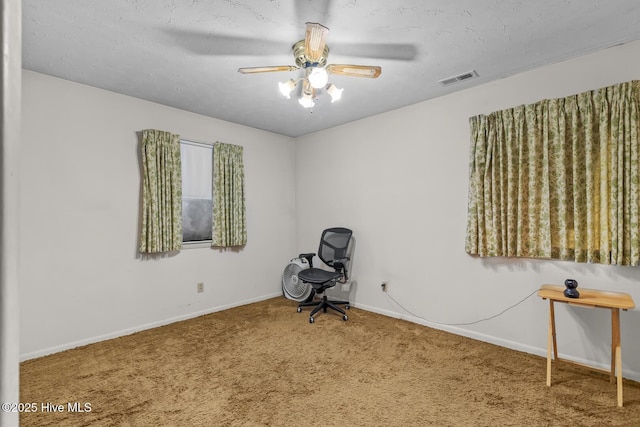 unfurnished room with ceiling fan, carpet floors, and a textured ceiling