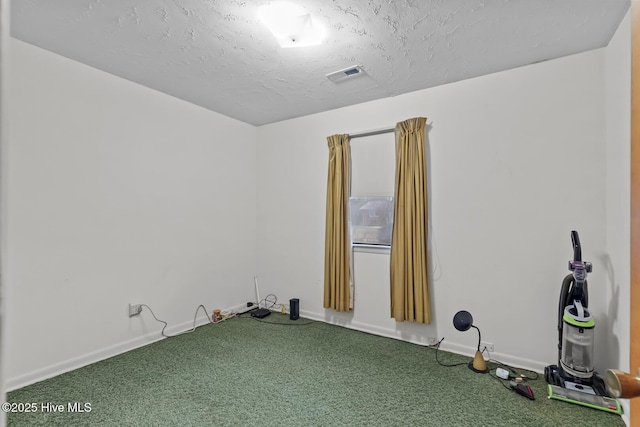 carpeted spare room featuring a textured ceiling