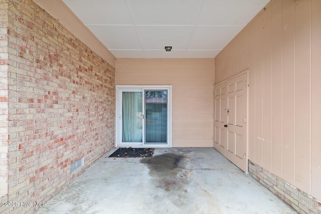 view of exterior entry featuring a patio