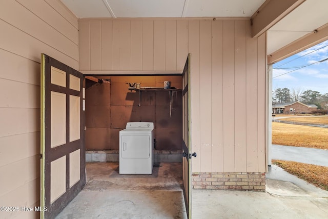 laundry area with washer / clothes dryer and wood walls