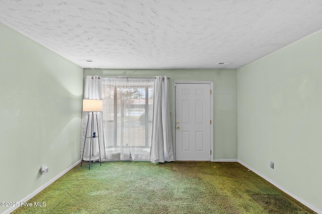 empty room featuring carpet floors and a textured ceiling