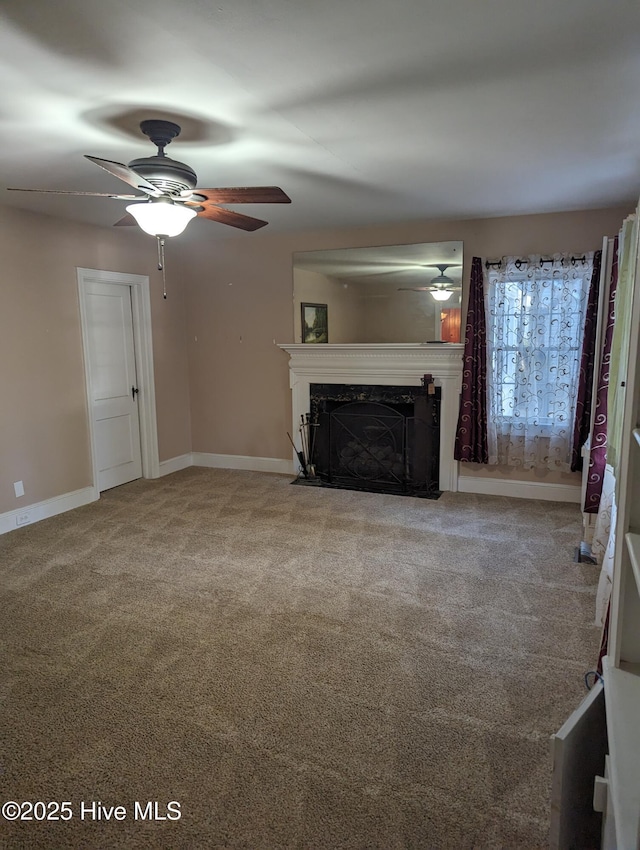 unfurnished living room featuring ceiling fan, a fireplace, and carpet floors