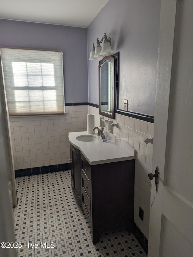 bathroom with vanity and tile walls