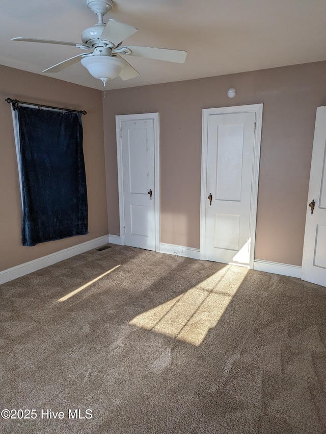 unfurnished bedroom with carpet floors and ceiling fan