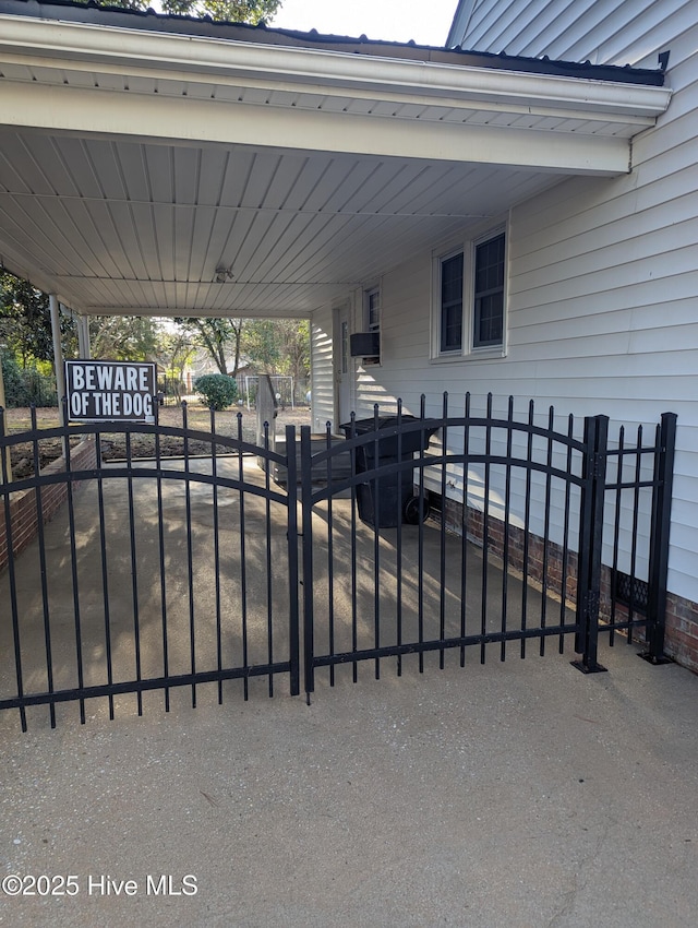 view of gate featuring a carport