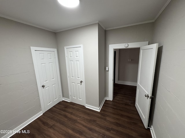 hallway featuring dark wood-type flooring and ornamental molding