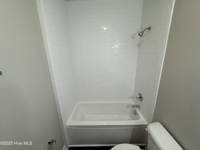 bathroom with shower / washtub combination and toilet