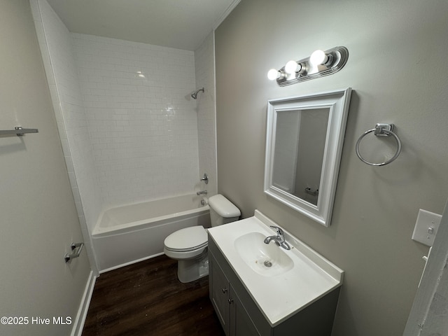 full bathroom with wood-type flooring, tiled shower / bath, vanity, and toilet