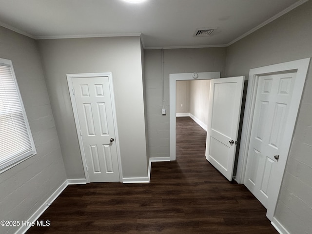 corridor with crown molding and dark hardwood / wood-style flooring