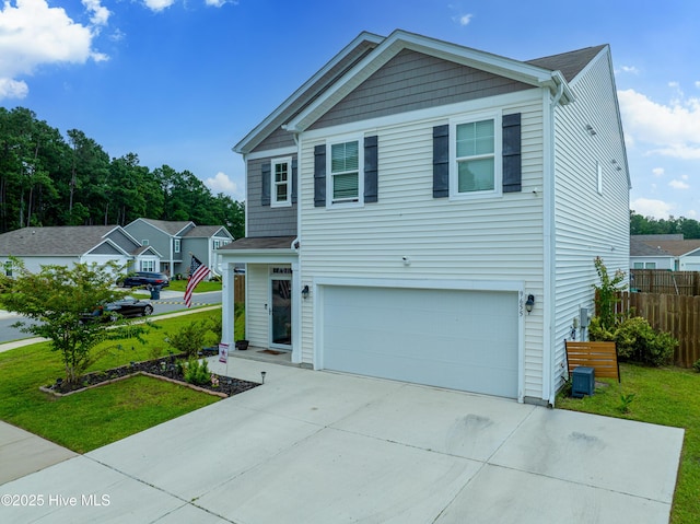 view of front of house with a garage and a front yard