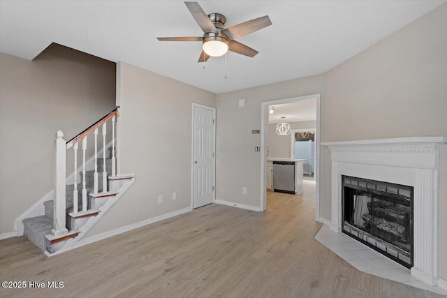 unfurnished living room featuring ceiling fan and light wood-type flooring