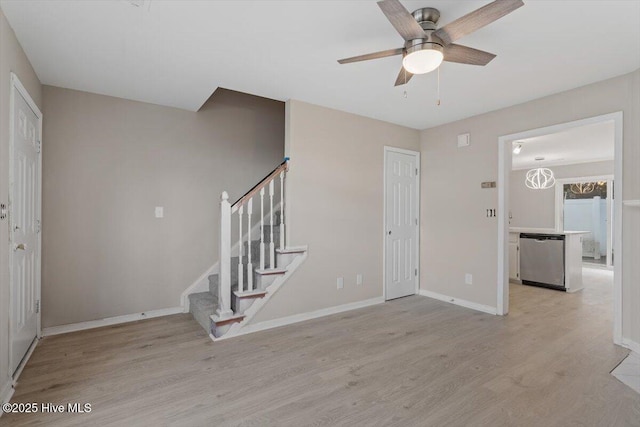 entryway with ceiling fan and light hardwood / wood-style flooring