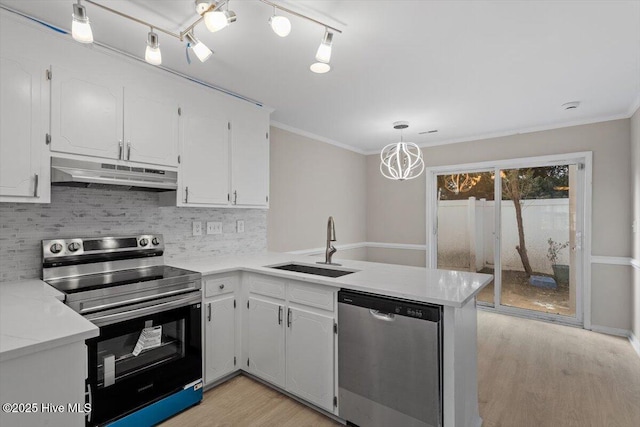 kitchen featuring pendant lighting, white cabinetry, kitchen peninsula, and appliances with stainless steel finishes