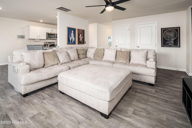 living room with hardwood / wood-style floors and ceiling fan