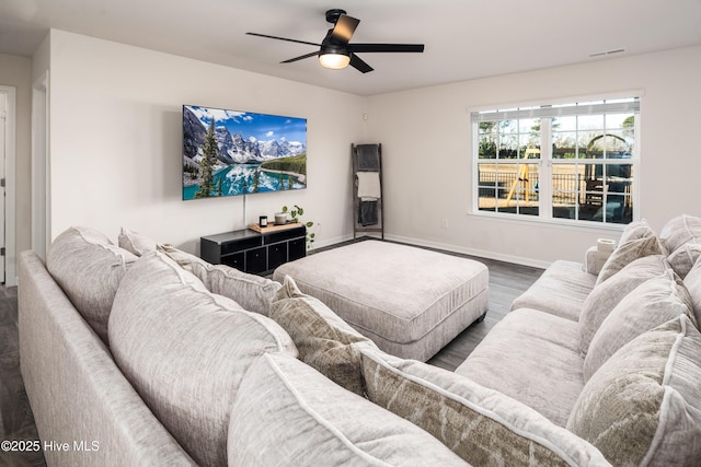 living room with ceiling fan and dark hardwood / wood-style flooring