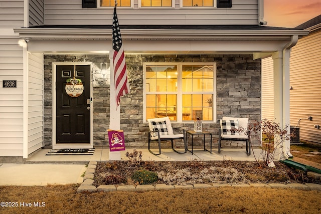 exterior entry at dusk with covered porch