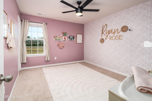 interior space with ceiling fan and light carpet