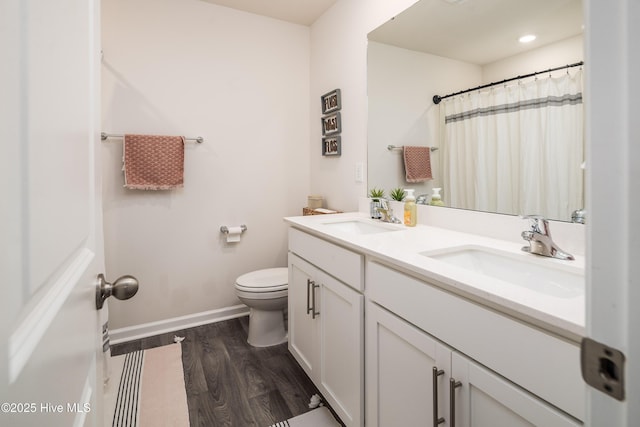 bathroom with vanity, toilet, and hardwood / wood-style floors