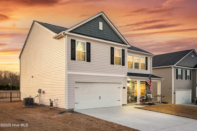 view of front of property featuring central AC unit and a garage