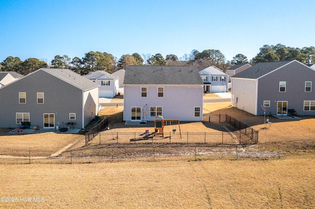 rear view of house with a yard