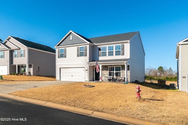 view of front of home with a garage and a front lawn