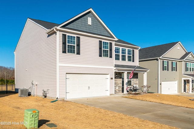 view of front of house with a garage and central AC unit