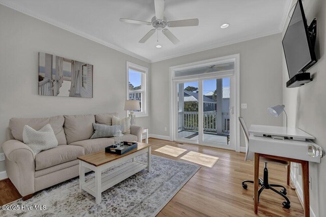 living room featuring crown molding, ceiling fan, and light hardwood / wood-style flooring