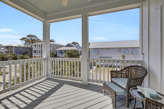 wooden terrace featuring a residential view and ceiling fan