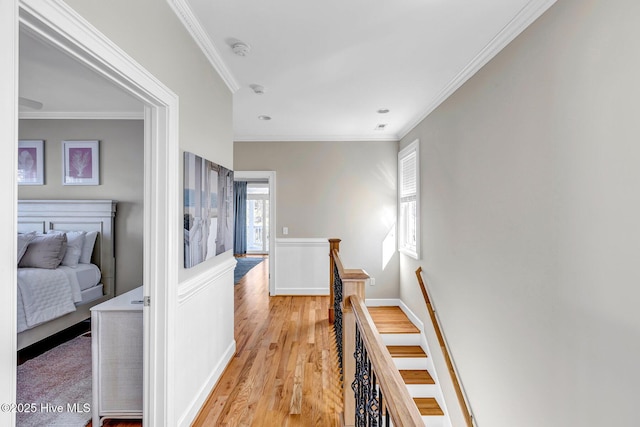 hall featuring ornamental molding and light hardwood / wood-style flooring