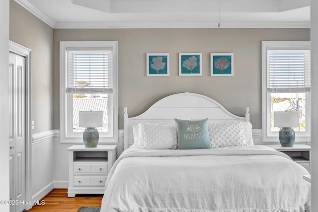 bedroom featuring hardwood / wood-style floors and ornamental molding