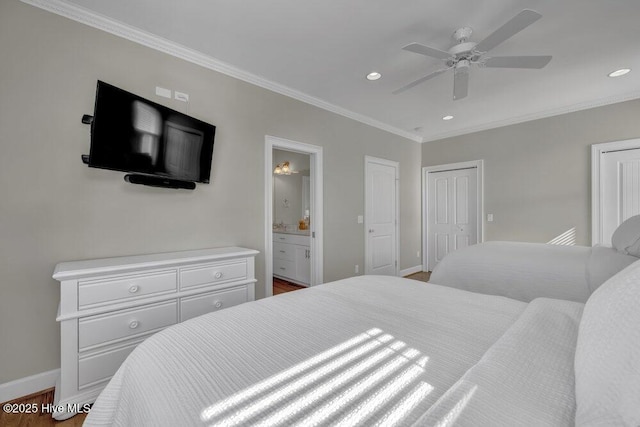 bedroom with baseboards, ensuite bathroom, crown molding, and recessed lighting